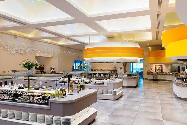 Innenansicht des Restaurants im Lyttos Beach Hotel mit vielen Speisen und heller Beleuchtung.