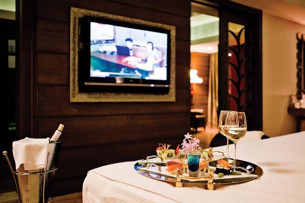 Zimmer im Cornelia Diamond Golf Resort & Spa mit Bett, Fernseher, Tisch und Getränken.