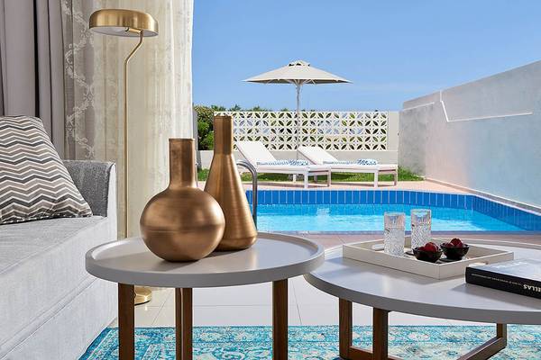 Wohnzimmer des Mythos Palace Resort & Spa mit Blick auf den Swimmingpool.