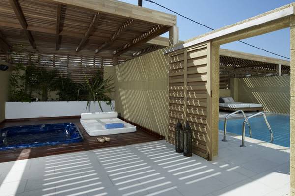 Außenbereich des Lindian Village Beach Resort Rhodes mit Whirlpool, Loungebett und Pool