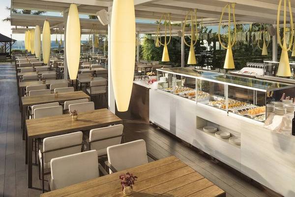 Restaurantbereich des Gran Melia Palacio de Isora mit Tischen, Stühlen und Speisen