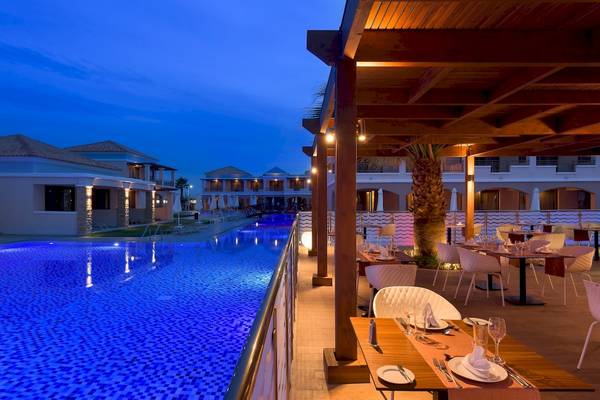 Außenbereich des La Marquise Luxury Resort Komplexes bei Nacht mit beleuchtetem Pool und Restaurants.
