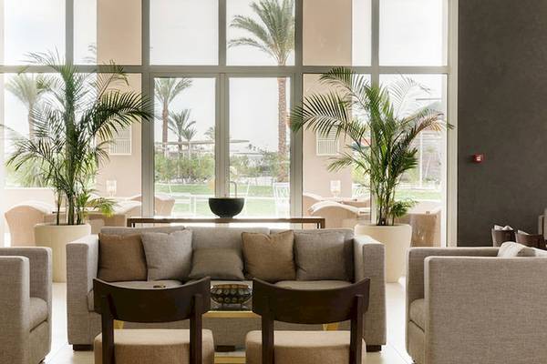 Lobby-Loungebereich des Jaz Aquaviva Hotels mit großen Fenstern, Pflanzen und Möbeln.