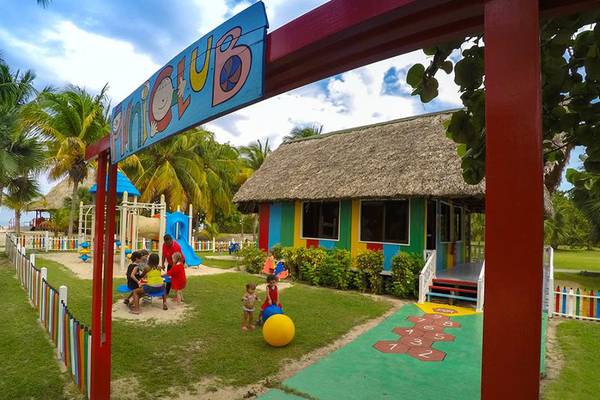 Kinderclub im ROC Arenas Doradas Hotel mit buntem Gebäude und Spielgeräten im Freien.