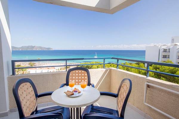 Balkon mit Meerblick im Hipotels Bahia Grande Hotel, mit Tisch, Orangensaft und Brot.