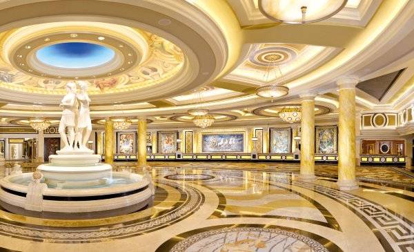 Innenbereich des Caesars Palace mit einer großen Brunnenskulptur und goldenen Säulen.