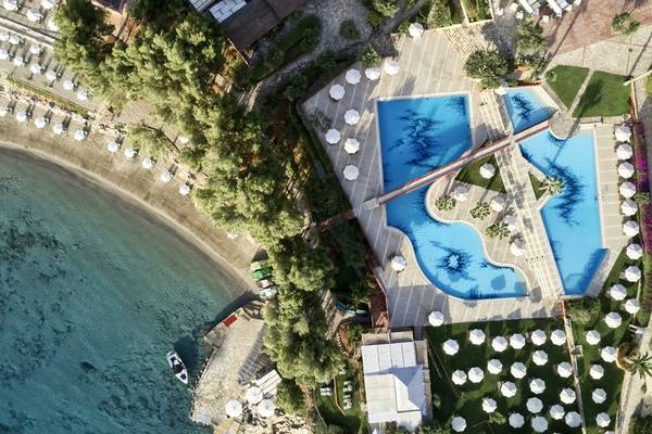 Luftaufnahme des Candia Park Village Hotels mit Pool, Strand und Sonnenschirmen