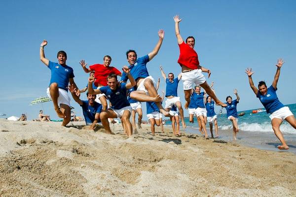 Gruppe junger Männer und Frauen springt am Strand des Club Hotel Marina Beach