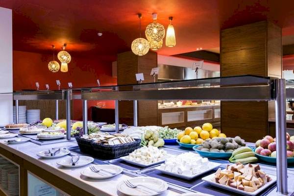 Buffet im AX Odycy Hotel mit verschiedenen Gerichten, Obst und Käseplatten.
