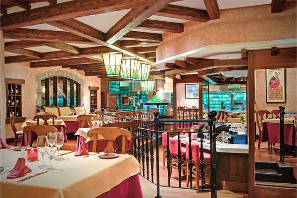 Innenbereich des Tivoli La Caleta Tenerife Resorts mit Holzdecken, Tischdekorationen und Weinflaschen