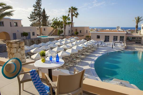 Pool-Bereich des Louis St. Elias Resort & Waterpark mit vielen Sonnenliegen und Schirmen.