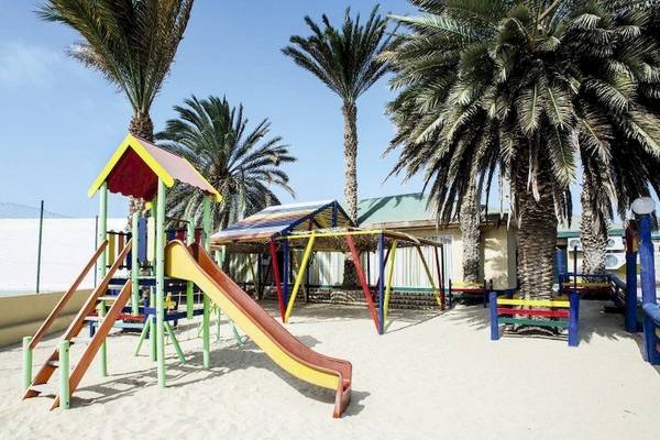 Spielplatz im Oasis Belorizonte Hotel, bunte Spielgeräte unter Palmen