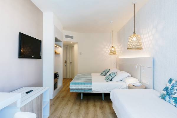 Doppelzimmer im Leonardo Royal Hotel Ibiza Santa Eulalia mit zwei Betten, Fernseher und Nachttisch