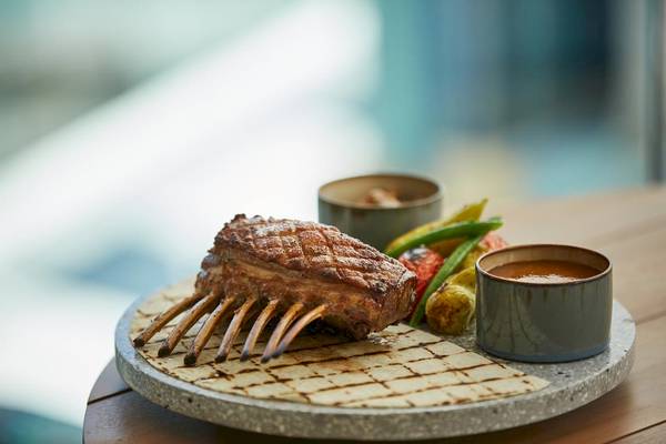 Gegrilltes Rippchen mit Beilagen auf einem Holztisch im LUX Grand Gaube Resort & Villas.