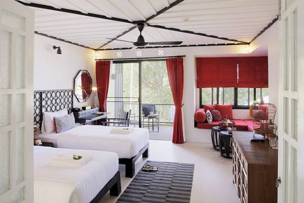 Schlafzimmer im Moracea by Khao Lak Resort mit zwei Betten, roter Vorhängen und einem Balkon