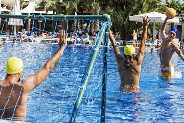 Gruppe von Männern spielt Wasserball im Pool des Magic Life Belek Hotels