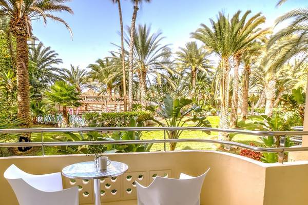 Balkon des Abora Catarina Hotel mit Blick auf tropische Palmen und Garten.