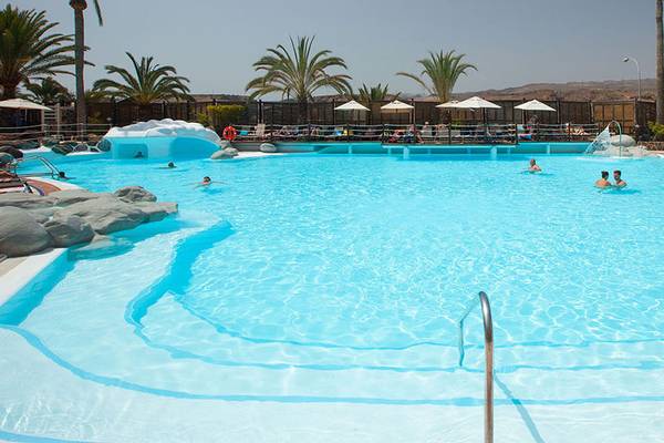 Außenpool im Abora Continental by Lopesan Hotel mit mehreren Schwimmern und Liegestühlen.