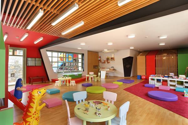 Kinderspielzimmer im Ikaros Beach Luxury Resort & Spa mit bunten Möbeln und Spielzeug.