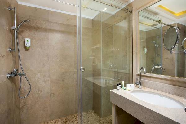Badezimmer im Pegasos Deluxe Beach Hotel mit Dusche und Waschbecken.