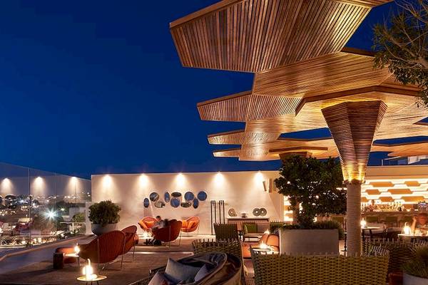 Nachtansicht der Dachterrasse des Myconian Naia Hotels mit Beleuchtung und Blick auf die Stadt
