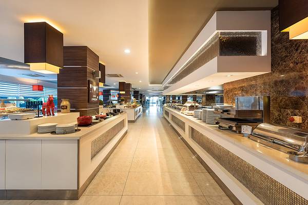 Innenansicht des Restaurants im White City Resort mit langen Tischen und Speisen.