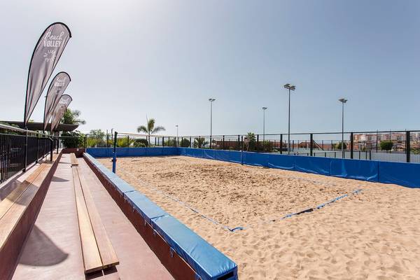 Beachvolleyballplatz im Landmar Costa Los Gigantes Hotel mit blauen Absperrungen und Bannern.
