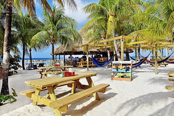 LionsDive Beach Resort Strand mit Loungebereichen und Palmen