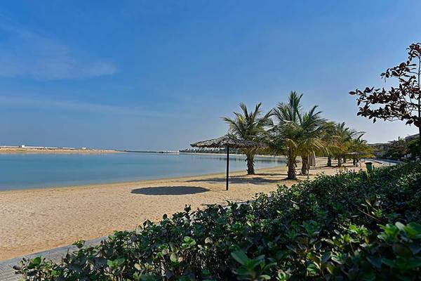 Jannah Hotels Resorts & Villas Strand mit Palmen und Sonnenschirmen