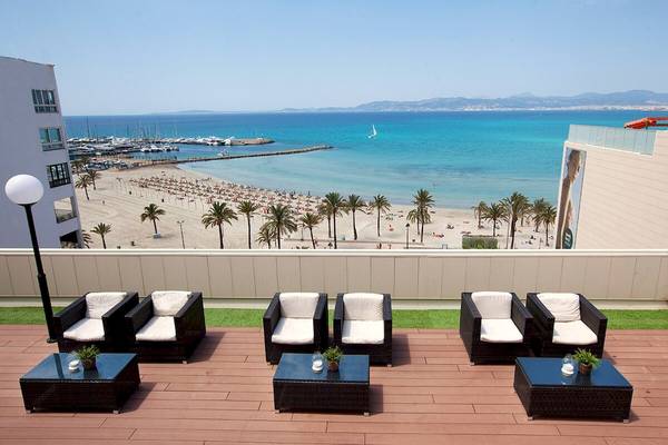 Aussicht von der Terrasse des Whala Beach Hotel auf den Strand mit vielen Liegen und Sonnenschirmen.