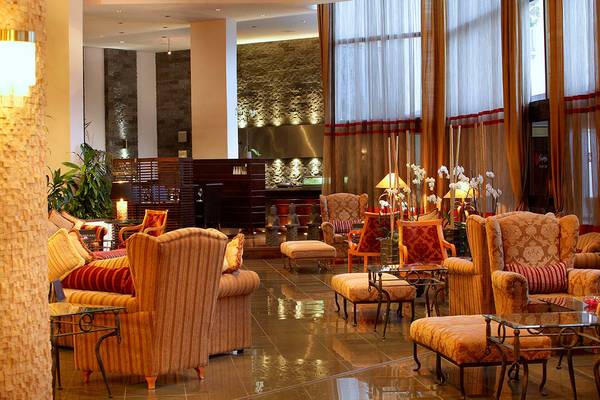 Innenansicht des GrandResort Limassol Hotels mit gepolsterten Sesseln und Tischen