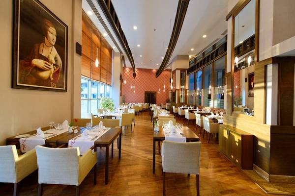 Innenansicht des Restaurants im Concorde De Luxe Resort mit gedeckten Tischen und Stühlen.