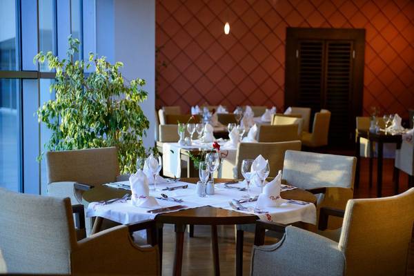 Restauranttisch im Concorde De Luxe Resort mit gedeckten Plätzen und Pflanzen im Vordergrund.