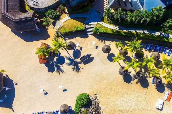 Luftaufnahme des Anelia Resort & Spa Strands mit Palmen, Sonnenliegen und Gebäuden