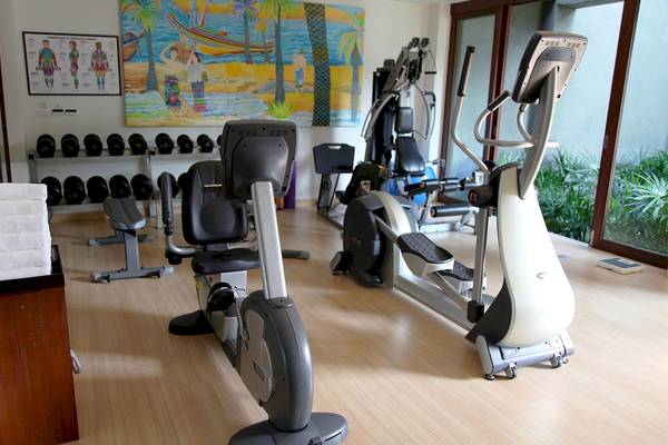 Fitnessstudio im Mai Samui Beach Resort & Spa mit verschiedenen Trainingsgeräten und einer bunten Wandmalerei.