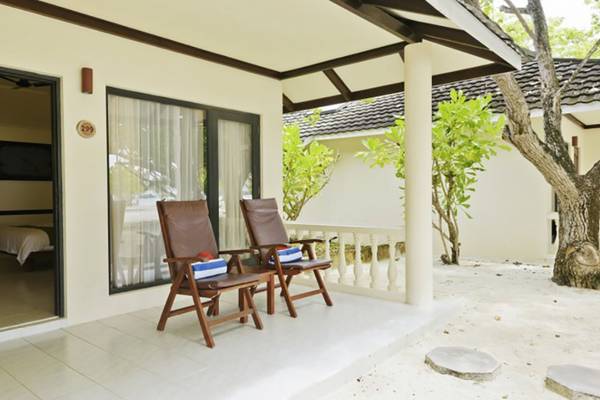 Terrasse des Villa Nautica Paradise Island Resorts mit zwei Stühlen und einem offenen Eingang.