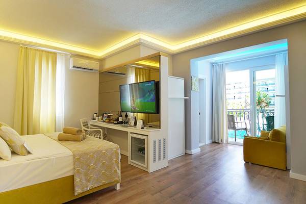 Hotelzimmer mit Bett, Fernseher, Schreibtisch und Balkon im Selectum Family Comfort Side
