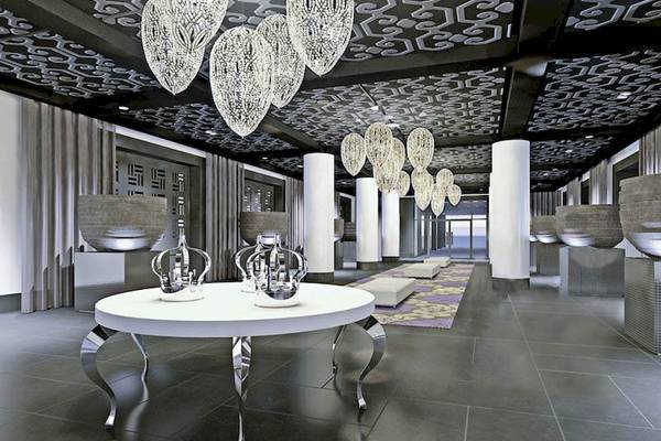 Empfangsbereich des Sofitel Agadir Thalassa Sea & Spa mit einem zentralen Tisch und Kronleuchtern.