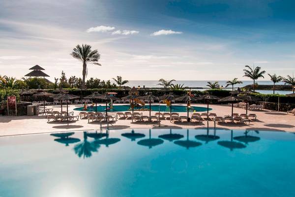Außenpool mit Liegestühlen und Sonnenschirmen im Sheraton Fuerteventura Beach, Golf & Spa Resort.