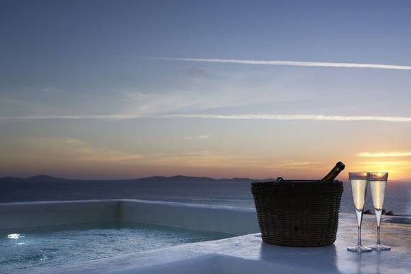 Terrasse des Rocabella Mykonos Art Hotel & Spa mit Blick auf den Sonnenuntergang.