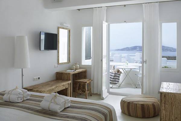 Zimmer im Rocabella Mykonos Art Hotel & Spa mit Blick auf den Garten und das Meer.