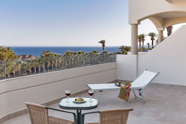 Balkon des Rodos Princess Beach Hotels mit Blick auf den Ozean und Palmen.