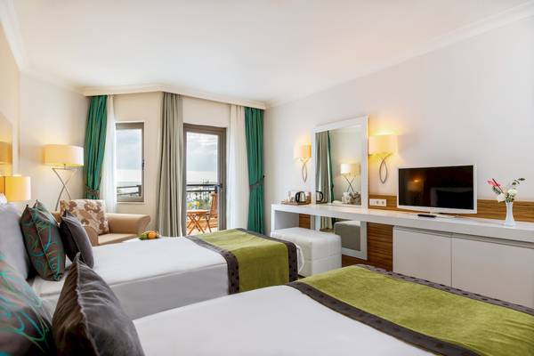Suite Zimmer im Asteria Family Resort Belek mit zwei Betten, Fernseher und Balkon.