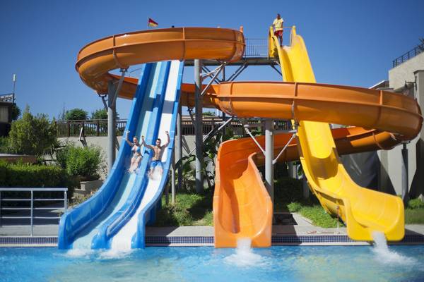 Wasserrutschen im Aydinbey Kings Palace & Spa Hotel mit mehreren Rutschen und Personen.