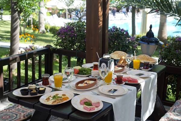 Frühstück auf der Terrasse im Aydinbey Kings Palace & Spa Hotel mit Blick auf den Pool.