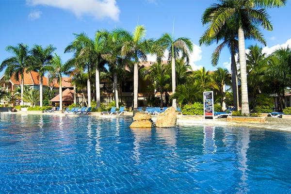 Außenpool des IFA Villas Bavaro Hotels mit Palmen und Liegestühlen.