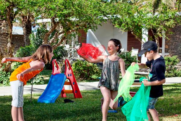 Kinder spielen mit Tulpen im Garten des Civitel Creta Beach Hotels.