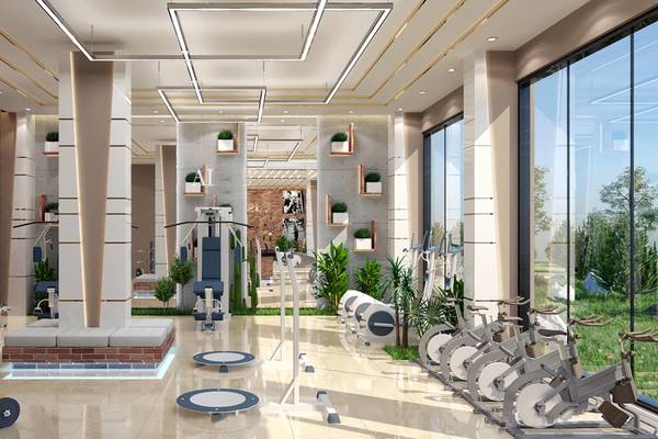 Innenansicht des Fitness-Centers im Belad Bont Resort mit modernen Geräten und Pflanzen.
