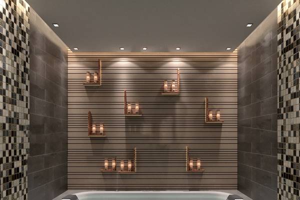 Innenansicht des Badezimmers im Belad Bont Resort mit Badewanne und dekorativen Wandleuchten.