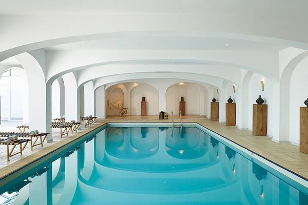 Innenpool des Grecotel Casa Marron Hotels mit weißen Wänden und blauem Wasser
